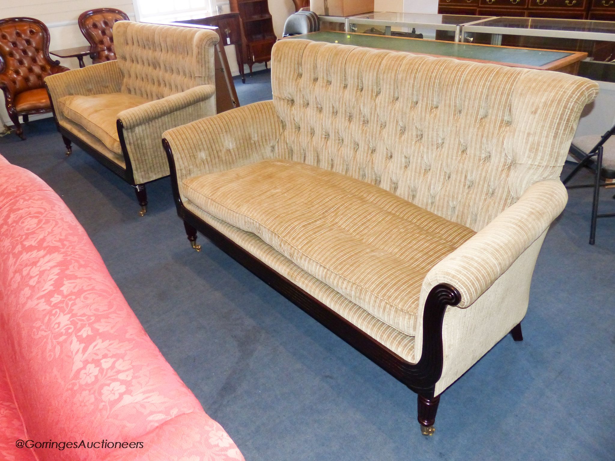 A pair of George IV style mahogany button back sofas, 181 cm wide